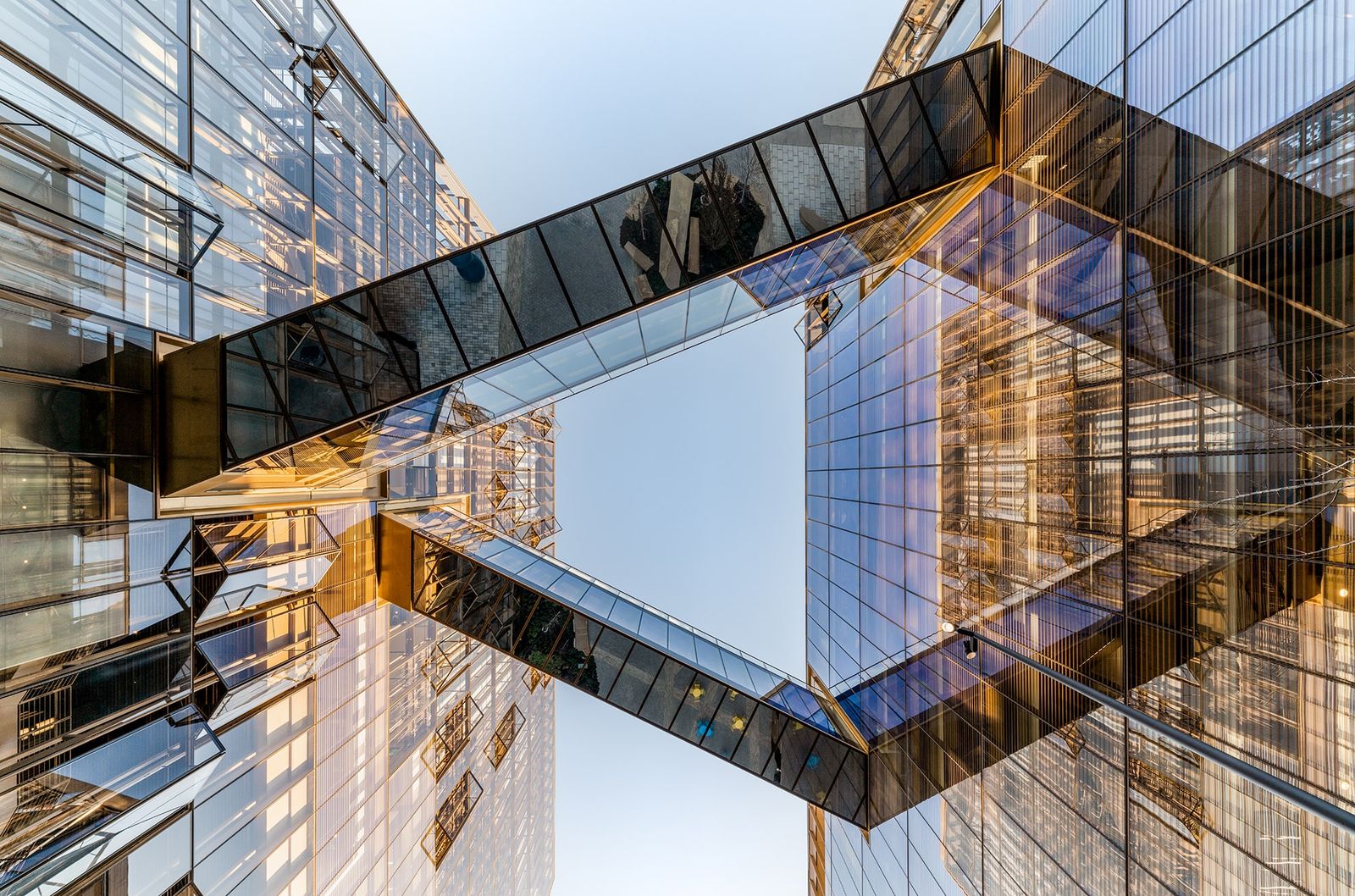 Architectural hero image of interconnected glass bridges and facades